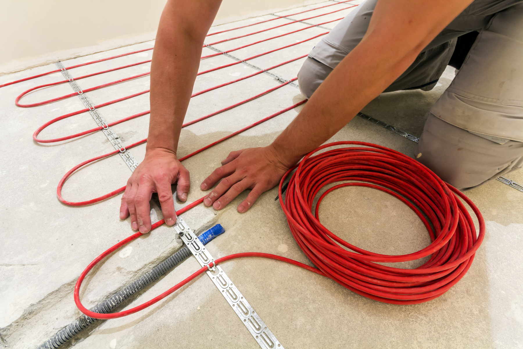 Electrician laying underfloor heating